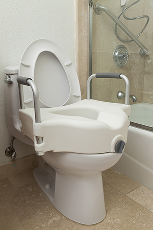Elevated commode seat on toilet.