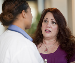 Woman talking to health care provider.
