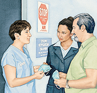 Health care provider giving masks to man and woman.