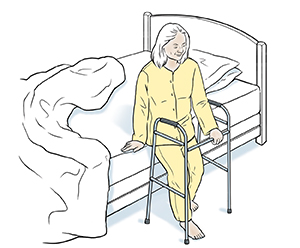 Woman sitting at edge of bed with walker.