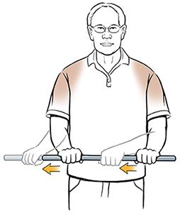Man doing external rotation shoulder exercise with wand.