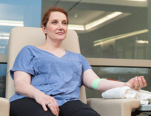 Woman in chair donating blood.
