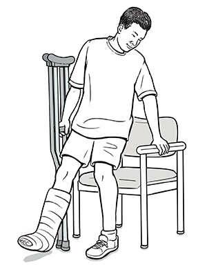 Man with crutches holding arm of chair, preparing to sit down.