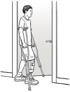 Man going through door with crutches.