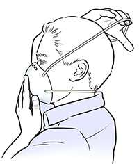 Man putting upper strap of dust mask over his head.