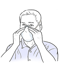 Man pressing nose seal of dust mask onto his nose.