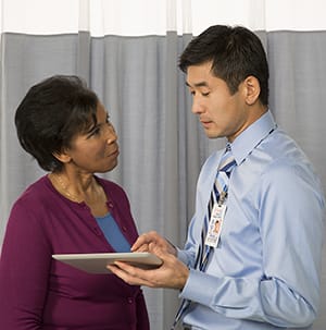 Woman talking to doctor.