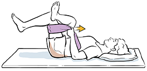 Woman lying on back with one leg crossed and ankle resting on opposite knee, which has towel placed around thigh. Woman is using towel to pull legs toward chest.