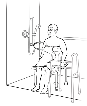 Mujer sentada en una silla de ducha con un andador colocado a un costado. La flecha muestra cómo girar el cuerpo hacia el cabezal de la ducha.